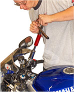 Lining up the cap, the spring, and the tube, then compressing the assembly